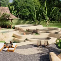 Park Landscape With Irregular Ponds Lounge Chairs Thatched Pavilion And Tropical Plants