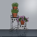 Decorative Black Iron Plant Stand With Terracotta Potted Green Herbs And Purple Flowers