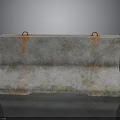Heavy Duty Concrete Barrier With Orange Lifting Rings And Rusty Surface Stains