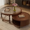 Round Glass Top Nesting Coffee Tables With Pink Flowers And Books On Wooden Floor