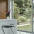 Modern Elegant Living And Dining Interior With Unique Circular Ceiling Light And Panoramic Outdoor Views