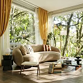 Sunny Living Room With Beige Sofa Decorative Pillows Yellow Curtains Large Windows And Forest View