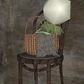 Woven Vase With Green Flowers Resting On Wooden Chair With Gray Cloth And Dark Background