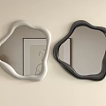 Two Irregular Shaped White And Black Mirrors On Light Colored Wall With Artwork Reflections