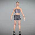 Woman Standing in Sports Bra Shorts and Sneakers Against Gray Background