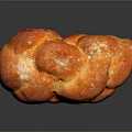Freshly Baked Braided Bread With Golden Brown Crust And Powdered Sugar Topping