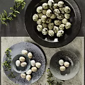 Elegant Dishware Set Featuring Black Gray Bowls Plates With Quail Eggs And Green Foliage