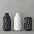 Geometric Textured Ceramic Vases in Black and White on Gray Wall