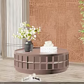 Round Brown Lattice Design Coffee Table With Vase Books And Green Plants On Wooden Floor