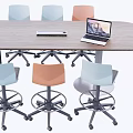 Wooden Conference Table With Laptop Keyboard And Colorful Chairs In Office