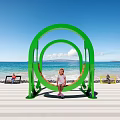 Green Circular Outdoor Chair On Beach With Ocean Blue Sky And Kids Relaxing