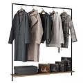 Stylish Coats And Jackets Hanging On Black Rack With Leather Bags And Boxes