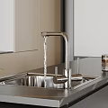 Modern Bathroom Sink Featuring Stainless Steel and Flowing Faucet on Dark Countertop with Light Cabinets