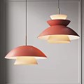 Pair Of Modern Multi Layered Pendant Lights With Red Textured Shades And Warm Glow