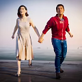 Couple Holding Hands Walking By Seaside In Light Dress And Red Jacket