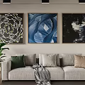 Modern Living Room With Three Decorative Paintings Light Gray Sofa Cushions And Green Plant