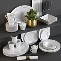 Modern White Dinnerware Set with Stacked Plates Cups Wine Glasses and Green Plant Decoration