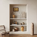 Minimalist Beige Niche With Shelves Displaying Rustic Pottery Candles And Sculptures
