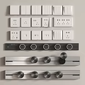 Different Types of Electrical Switches and Sockets in White and Metallic Finishes Arranged on Wall