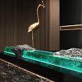 Golden Crane Sculpture With Green Water Feature Stone And Wooden Background In Modern Decor