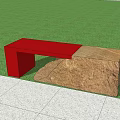 Red And Natural Stone Outdoor Bench In Garden With Green Plants And Grass