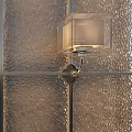 Contemporary Wall Lamp with Square Shade Mounted on Textured Wall and Metal Bracket