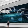 Woman Standing Before Huge Screen Showing Aircraft Tech Lines And Data Charts