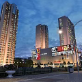 Evening Commercial Street Featuring Shopping Mall Tall Buildings Billboards Street Lamps Benches And Green Plants