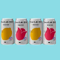 Four Tea Lab Canned Drinks With Yellow And Pink Designs On Light Blue Background