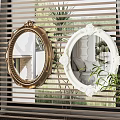 Decorative Gold And White Framed Mirrors Hanging On Wall With Window Blinds And Green Plants