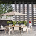 Outdoor Chairs Set With Table And Umbrella In Patio Garden With Greenery And Lattice Wall