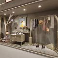 Ochirly Shop Window Display With Tree Like Decorations Hanging Clothes Hats And Shoes