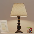 Black Base Table Lamp With Beige Fabric Lampshade White Photo Frame Small Plant Cartoon Figurine
