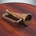 Vintage Brass Trumpet Musical Instrument on Wooden Tabletop with Worn Copper Texture