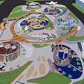 Outdoor Children's Playground With Circular Play Features Colorful Design And Green Areas