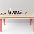 Light Wooden Desk with Pink Legs Stationery Colorful Paint Bottles Scissors Pencils and Paper
