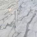Elegant Modern Chrome Faucet With Sleek Design And Tall Spout On Marble Surface