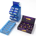 Chocolatier Chocolate Display Stand With Blue Packaging And Open Purple Box Of Chocolate Balls