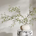 White Vase With Green Leaf Branches Placed On Black And White Patterned Pedestal Light Wall