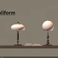 Poliform Table Lamps with Orange Shades and Metal Bases on Wooden Shelf with Open Book