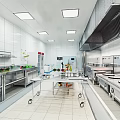 Modern Commercial Kitchen Interior With Stainless Steel Worktables Range Hood And White Tiled Walls