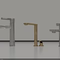 Three Modern Water Faucets in Silver and Gold Finishes on Light Countertop