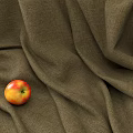 Red Yellow Apple Placed On Brown Textured Fabric With Soft Folds
