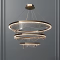 Modern Three Tier Circular Chandelier With Wavy Lines And Warm Metallic Lighting