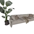 Beige Sectional Sofa with Plaid Pillows Cozy Blanket and Green Plant in Living Room