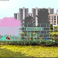 Modern Geometric Stone Feature Wall In Urban Landscape With Green Trees And High Rise Buildings