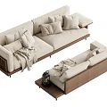Beige Multi Seater Sofa With Wooden Frame Pillows Blanket And Matching Ottoman Side Table Lantern