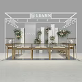 Luxury Jewelry Store Display Area Featuring Golden Counters White Columns Flower Decorations And Spotlights