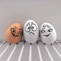 Three Painted Eggs With Happy Sad and Smiling Faces On White Striped Tray