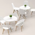 White Round Dining Table And Chairs Set With Wooden Legs And Small Plant